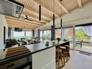 an open kitchen and living room with a large island at Villa Loqua, Seaview & Private Pool in Lovran +29 photos