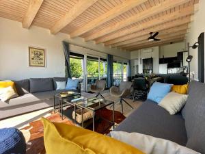a living room with a couch and a table at Villa Loqua, Seaview & Private Pool in Lovran