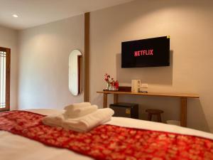 Postel nebo postele na pokoji v ubytování Baan Daeng Resort บ้านรักไทย
