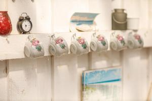 a shelf with clocks and a clock on it at Ranna Surfiküla in Suureranna