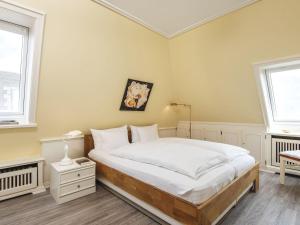 a bedroom with a bed and two windows at Nautilus-12 in Kampen