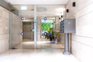 a lobby with a glass door in a building at Beautiful 2BDR close to Bialik Place by HolyGuest in Tel Aviv