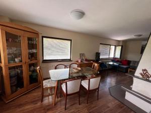 a dining room with a glass table and chairs at Villa Villekulla in Chukovezer