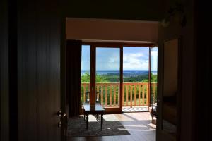 a door leading to a balcony with a view of the ocean at Agriturismo Gradec in Aurisina