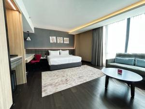 a hotel room with a bed and a couch at Jazz Hotel Penang in George Town