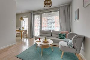 a living room with a couch and a table at Chmielna Park 5 TriApart® in Gdańsk