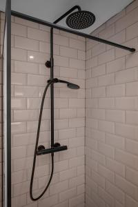 a shower with a shower head in a bathroom at Accommodation Fifty-Nine in Blackpool