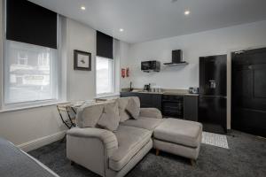 a living room with a couch and a kitchen at St Chads Suites by Central Beach Leisure in Blackpool +34 photos