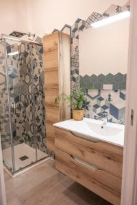 a bathroom with a sink and a shower at antica dogana apartments scirocco in Terracina