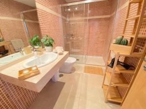 a bathroom with a sink and a toilet and a shower at Casa Blanca Caleta - Golf & Sea Views - private heated Saltwater Pool - BBQ - Aircondition" in Caleta De Fuste +14 photos