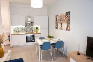 a kitchen and dining room with a table and chairs at antica dogana apartments scirocco in Terracina