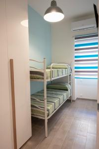 a room with a bunk bed in a room at antica dogana apartments scirocco in Terracina