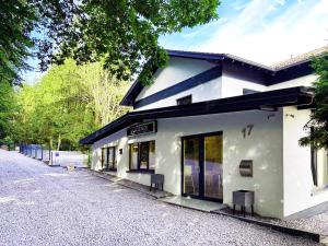 a white building with two doors on a street at Gästehotel Lucendi Premium Lounge in Hohenleimbach