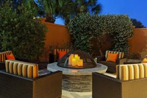 a patio with a fire pit with chairs and a table at Courtyard by Marriott Gainesville FL in Gainesville