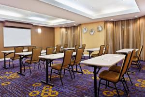 a conference room with tables and chairs and a whiteboard at Courtyard by Marriott Gainesville FL in Gainesville