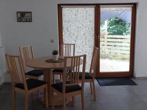 comedor con mesa, sillas y ventana en Landhaus im Tobel, en Bad Waldsee