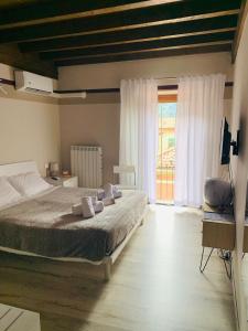 a bedroom with a bed and a large window at Residenza Lisy in Verbania
