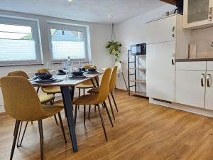 a kitchen and dining room with a table and chairs at Tucan - Rooftop Terrace with View, BBQ, PS4+Stream in Marburg an der Lahn