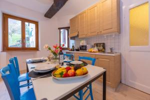 a kitchen with a table with a bowl of fruit on it at Casa Gialla - Happy Rentals in Pugerna