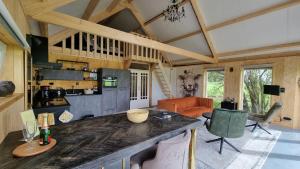 a kitchen and living room with a large counter top at City Farmers Lodge, a Guesthouse with a skyline view in Rural Amsterdam in Amsterdam