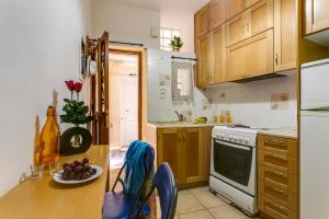 a kitchen with a table with a plate of fruit on it at Ifigenia Rooms in Chania