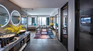 a bathroom with two sinks and a table with chairs at True Go S Hotel - Shenzhen Convention and Exhibition Center Union Square Branch in Shenzhen