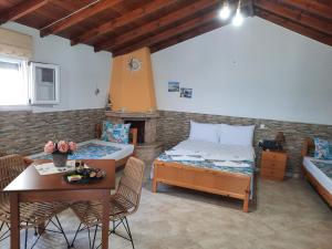 a room with a bed and a table and a tableablish at Avgoustos Beach House in Skala Kallirachis
