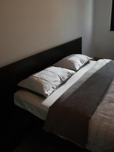 a bed with two pillows on it in a room at BTA Apartment Park Lake in Cluj-Napoca
