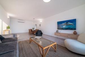 sala de estar con sofá y mesa en Beachfront apartment with breathtaking sea view, en Netanya