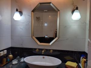 a bathroom with a sink and a mirror at Mastixi in Chios +49 photos
