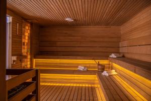 an empty sauna with wooden walls and wooden floors at Balneo Hotel Zsori Thermal & Wellness in Mezőkövesd