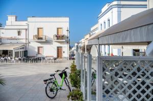 a bike parked on a sidewalk next to a building at Torre di Calasetta Cozy Apartment in Calasetta