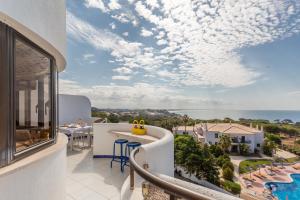 a room with a balcony with a view of the ocean at Coral By Albufeira Rental in Albufeira