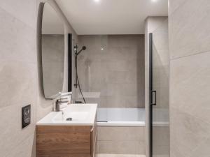 a bathroom with a sink and a mirror and a shower at Appartement familial, moderne et équipé, à proximité des pistes – Courchevel Le Praz - FR-1-568-39 in Courchevel
