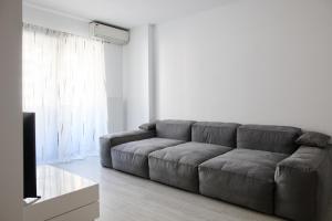 a living room with a couch and a television at BTA Apartment Park Lake in Cluj-Napoca +29 photos