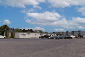 a parking lot with cars parked in front of a building at Travelodge by Wyndham Miramichi New Brunswick in Miramichi