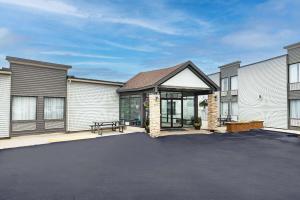 an empty parking lot in front of a house at Travelodge by Wyndham Miramichi New Brunswick in Miramichi