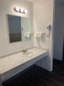a bathroom with a sink and a mirror at Western Inn Lakewood in Lakewood +37 photos