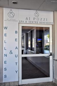 una puerta a la entrada del spas centresteensteensteensteensteen en Ai Pozzi Village Resort & SPA en Loano