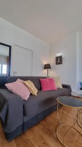 a living room with a couch and a table at Vânători Nest - 2 room - Pumo properties in Bucharest