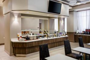 a restaurant with a counter with tables and chairs at Residence Inn Houston Downtown/Convention Center in Houston