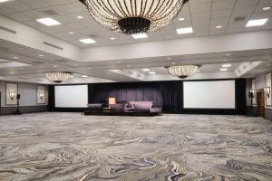 a large ballroom with a large room with two screens at Cheyenne Mountain Resort, a Dolce by Wyndham in Colorado Springs