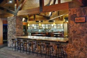 a bar in a restaurant with bar stools at Cheyenne Mountain Resort, a Dolce by Wyndham in Colorado Springs