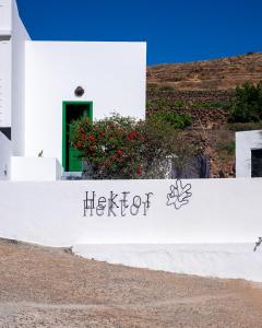 a white building with a sign that says hector at Hektor in Teguise