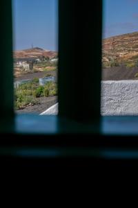 a view from a window of a road and a river at Hektor - farm, arts & suites in Teguise