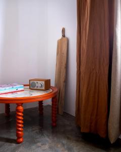 a table with a box on top of it next to a wooden table at Hektor - farm, arts & suites in Teguise