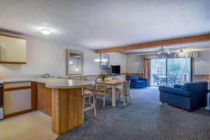 a kitchen and living room with a table and chairs at Southcape Resort Mashpee a Ramada by Wyndham in Mashpee