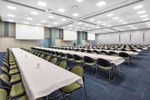 an empty lecture hall with tables and chairs at Microtel Inn & Suites by Wyndham Summerside in Summerside +22 photos
