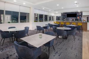 a restaurant with tables and chairs and a bar at Microtel Inn & Suites by Wyndham Summerside in Summerside