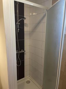 a shower with a glass door in a bathroom at Maison Du Lac in Marcillac-la-Croisille